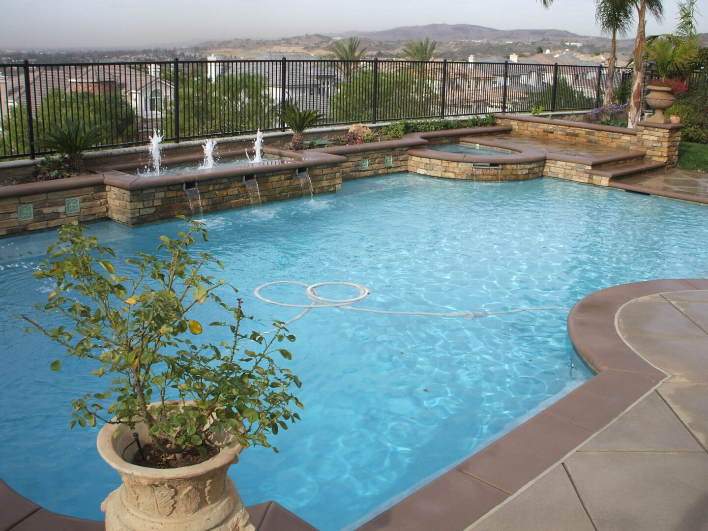 A pool with a fence on one side