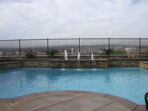 A pool with a fence on one side (1)