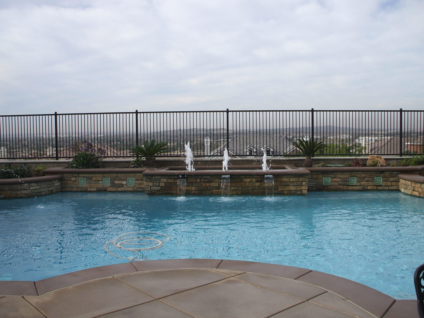 A pool with a fence on one side (1)