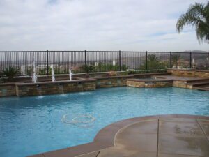 A pool with a fence on one side (2)