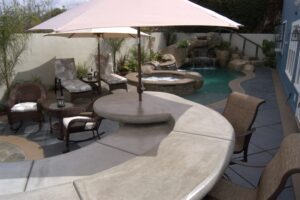 Dry sitting area with umbrellas and a pool behind