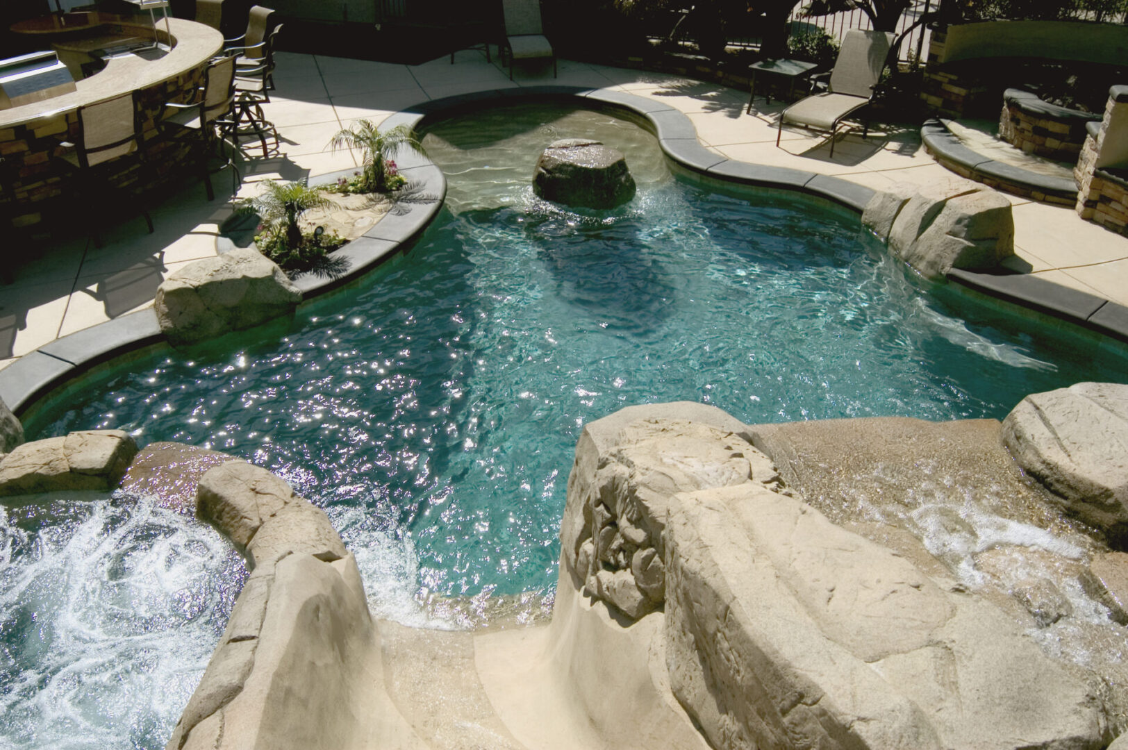 An irregular-shaped pool with a slide system