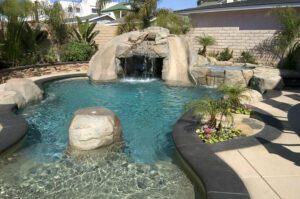 An irregular pool with a cave and falls