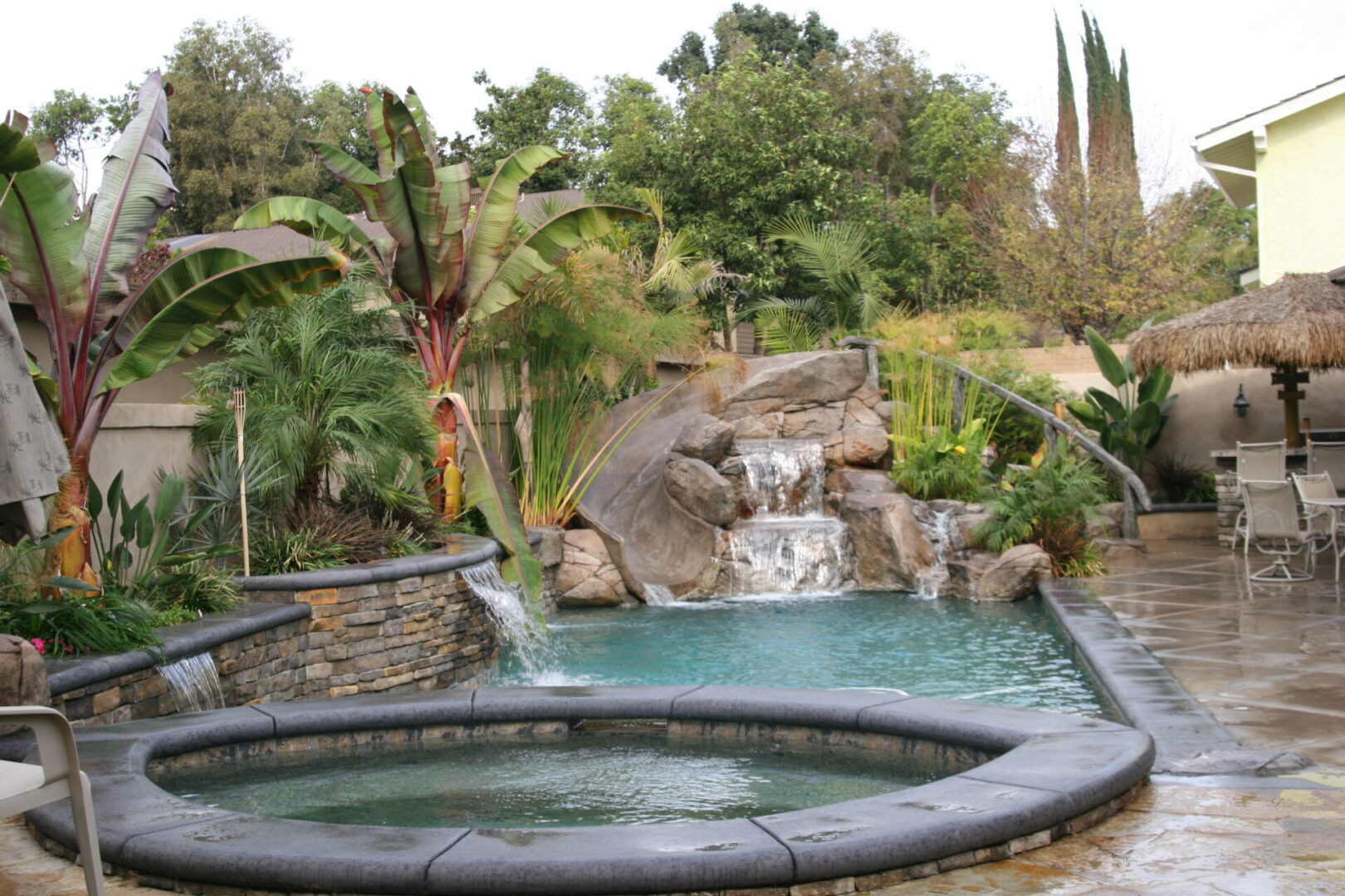 A pool with a smaller hot tub