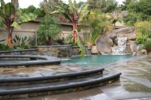 A pool with waterfalls on the side