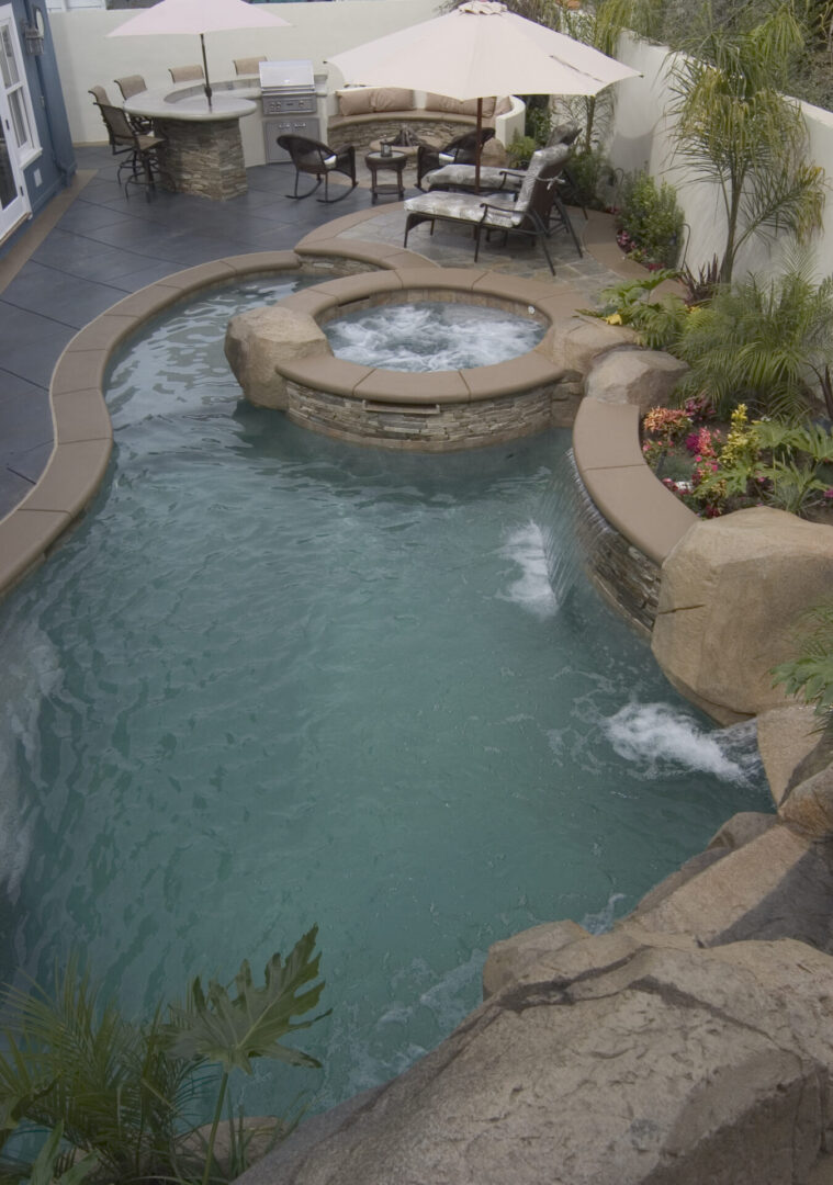 An irregular pool with falls and a smaller round pool (aerial view)