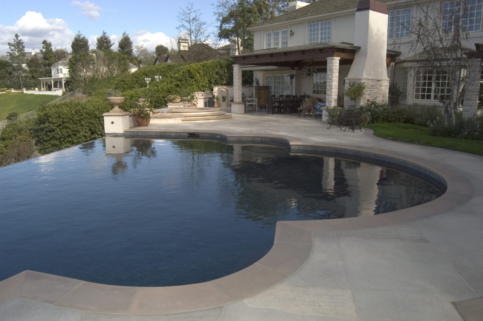 An infinity pool overlooking a mountain (facing the house)