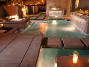 An indoor pool lighted by candles