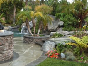 A pool’s waterfalls system surrounded by plants