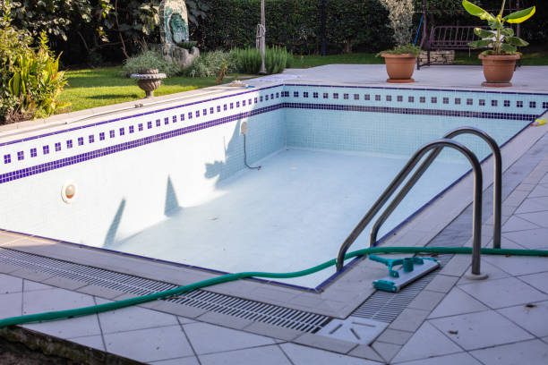 A small swimming pool with a hose, surrounded by a serene outdoor setting, perfect for relaxation and leisure, in Riverside, CA.