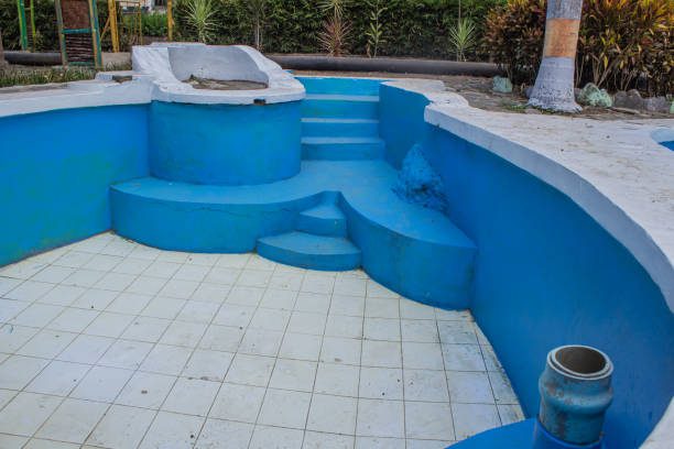 The swimming pool is not filled with water, undergoing renovation by a leading pool replastering service in Riverside, CA.