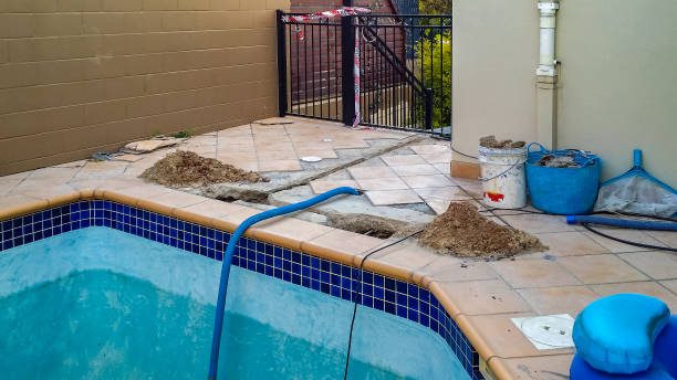 Swimming pool under pool replastering service in Ontario, CA, with caution tape marking the construction area for safety.